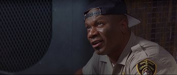 Movie still from “Con Air” (1997), directed by Simon West – A man with a hat on looking into the distance; Close Up shot, Low angle