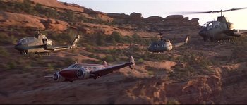 Movie still from “Con Air” (1997), directed by Simon West – A plane and a helicopter are flying in the air; Extreme Wide shot, Low angle