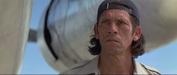 Movie still from “Con Air” (1997), directed by Simon West – A person with long hair wearing a hat; Close Up shot, Low angle