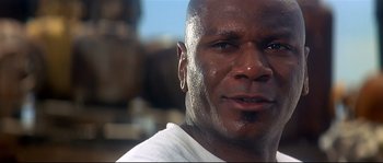 Movie still from “Con Air” (1997), directed by Simon West – A man's face with a white shirt on; Close Up shot, Low angle