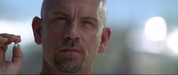 Movie still from “Con Air” (1997), directed by Simon West – A man's face with a beard; Close Up shot, Low angle