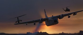 Movie still from “Con Air” (1997), directed by Simon West – An airplane is flying through the sky at sunset; Wide shot, Low angle