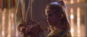 Movie still from “Con Air” (1997), directed by Simon West – A little girl sitting in front of an older woman; Close Up shot, Over the shoulder angle