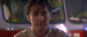 Movie still from “Con Air” (1997), directed by Simon West – A person with wet hair; Close Up shot, Low angle