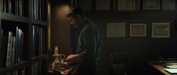 Movie still from “The Boogeyman” (2023), directed by Rob Savage – A man standing in front of a table with food on top of it; Medium shot, Over the shoulder angle