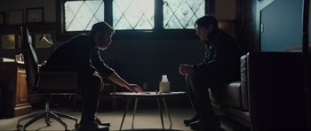 Movie still from “The Boogeyman” (2023), directed by Rob Savage – Two men sitting at a table playing a board game; Medium shot, Over the shoulder angle