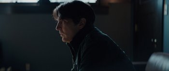 Movie still from “The Boogeyman” (2023), directed by Rob Savage – A man in a black jacket looking to his left; Close Up shot, Over the shoulder angle