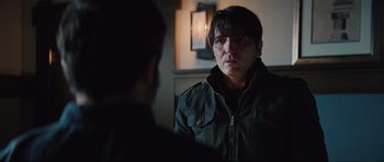 Movie still from “The Boogeyman” (2023), directed by Rob Savage – A man in a green jacket looking at another man in a black jacket; Close Up shot, Over the shoulder angle