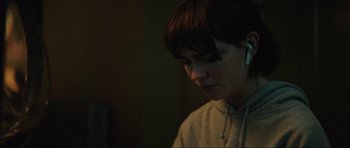 Movie still from “The Boogeyman” (2023), directed by Rob Savage – A person with a white ear bud in their ear; Close Up shot, Over the shoulder angle