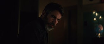 Movie still from “The Boogeyman” (2023), directed by Rob Savage – A man with a gray beard is looking at the camera; Close Up shot, Over the shoulder angle