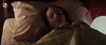 Movie still from “The Boogeyman” (2023), directed by Rob Savage – A little girl laying in a bed with a teddy bear; Close Up shot, High angle