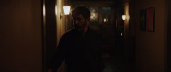 Movie still from “The Boogeyman” (2023), directed by Rob Savage – A man standing in a dark room at night; Medium shot, Over the shoulder angle