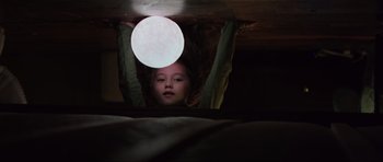 Movie still from “The Boogeyman” (2023), directed by Rob Savage – A young girl hanging from the ceiling under a bed; Medium shot, Low angle
