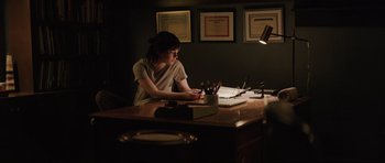Movie still from “The Boogeyman” (2023), directed by Rob Savage – A woman sitting at a desk writing on a piece of paper; Medium shot, High angle