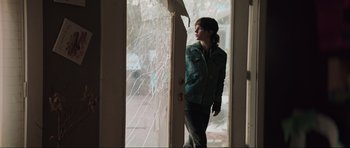 Movie still from “The Boogeyman” (2023), directed by Rob Savage – A woman standing in front of a broken glass window; Medium shot, Low angle
