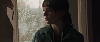 Movie still from “The Boogeyman” (2023), directed by Rob Savage – A woman looking out of a window at the trees; Close Up shot, Over the shoulder angle