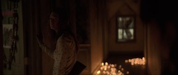 Movie still from “The Boogeyman” (2023), directed by Rob Savage – A woman standing next to a fire pit; Medium shot, Over the shoulder angle