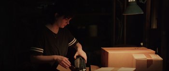 Movie still from “The Boogeyman” (2023), directed by Rob Savage – A woman in black shirt pouring coffee into a coffee pot; Medium shot, Over the shoulder angle