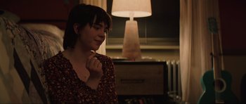 Movie still from “The Boogeyman” (2023), directed by Rob Savage – A woman is standing in front of a lamp; Close Up shot, Over the shoulder angle