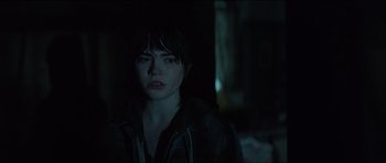 Movie still from “The Boogeyman” (2023), directed by Rob Savage – A woman in a dark room looking at the camera; Close Up shot, Over the shoulder angle