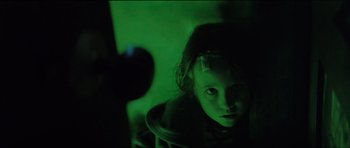 Movie still from “The Boogeyman” (2023), directed by Rob Savage – A little girl is sitting in a dark room; Close Up shot, Over the shoulder angle