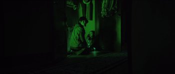 Movie still from “The Boogeyman” (2023), directed by Rob Savage – A boy and a little girl sitting on the floor in a dark room; Medium shot, High angle