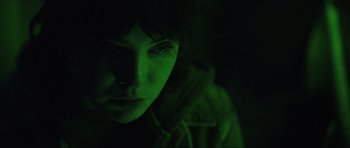 Movie still from “The Boogeyman” (2023), directed by Rob Savage – A person with a green light on their face; Close Up shot, High angle