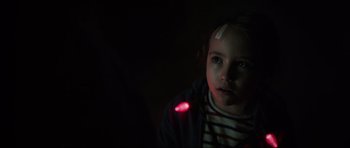 Movie still from “The Boogeyman” (2023), directed by Rob Savage – A little girl with a light in her ear; Close Up shot, Over the shoulder angle