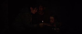 Movie still from “The Boogeyman” (2023), directed by Rob Savage – A man and a woman and a little girl holding a candle; Medium shot, High angle