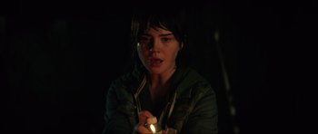 Movie still from “The Boogeyman” (2023), directed by Rob Savage – A woman is holding a lit candle in the dark; Close Up shot, Low angle