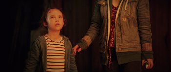 Movie still from “The Boogeyman” (2023), directed by Rob Savage – A woman holding a child's hand while standing next to a girl; Medium shot, Over the shoulder angle