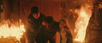 Movie still from “The Boogeyman” (2023), directed by Rob Savage – A man and two children are standing in a room; Medium shot, High angle