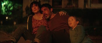 Movie still from “The Boogeyman” (2023), directed by Rob Savage – A man and a woman and a child sitting on a couch; Medium shot, High angle