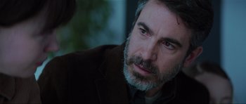 Movie still from “The Boogeyman” (2023), directed by Rob Savage – A person with a beard; Close Up shot, Over the shoulder angle