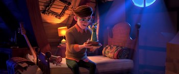 Movie still from “The Boss Baby 2: Family Business” (2021), directed by Tom McGrath – A person sitting on a bed holding a phone; Wide shot, High angle