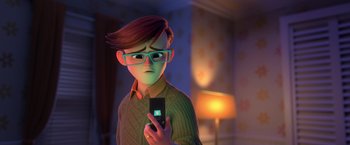 Movie still from “The Boss Baby 2: Family Business” (2021), directed by Tom McGrath – A man with glasses is holding a cell phone; Close Up shot, Over the shoulder angle