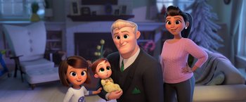 Movie still from “The Boss Baby 2: Family Business” (2021), directed by Tom McGrath – A man holding a baby in his arms next to a woman and a girl; Medium shot, Over the shoulder angle