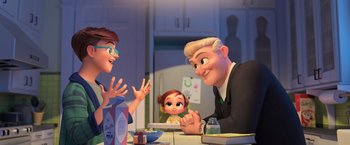 Movie still from “The Boss Baby 2: Family Business” (2021), directed by Tom McGrath – A couple of people sitting at a table with a child; Medium shot, Over the shoulder angle