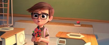 Movie still from “The Boss Baby 2: Family Business” (2021), directed by Tom McGrath – A cartoon boy holding a flower pot in a classroom; Close Up shot, Over the shoulder angle