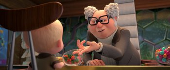 Movie still from “The Boss Baby 2: Family Business” (2021), directed by Tom McGrath – An old man with glasses is talking to a young man; Close Up shot, Over the shoulder angle