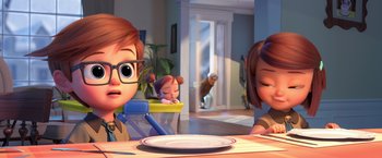 Movie still from “The Boss Baby 2: Family Business” (2021), directed by Tom McGrath – A couple of people sitting at a dinner table; Medium shot, Over the shoulder angle