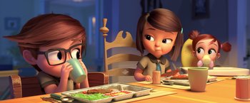 Movie still from “The Boss Baby 2: Family Business” (2021), directed by Tom McGrath – A girl sitting at a table with a tray of food in front of her; Medium shot, Over the shoulder angle