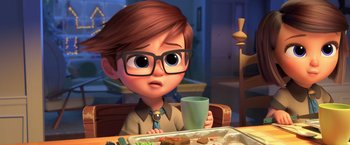 Movie still from “The Boss Baby 2: Family Business” (2021), directed by Tom McGrath – A boy with glasses is sitting at a table with food; Close Up shot, Over the shoulder angle