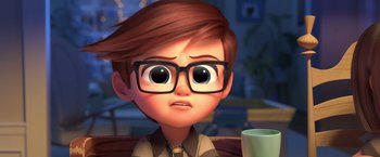 Movie still from “The Boss Baby 2: Family Business” (2021), directed by Tom McGrath – A cartoon boy with glasses is sitting at a table with a coffee cup; Close Up shot, Over the shoulder angle