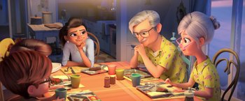 Movie still from “The Boss Baby 2: Family Business” (2021), directed by Tom McGrath – An old man sitting at a table next to a young girl; Medium shot, Over the shoulder angle