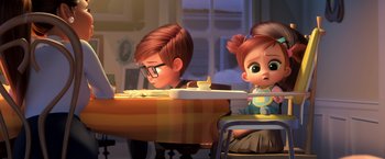 Movie still from “The Boss Baby 2: Family Business” (2021), directed by Tom McGrath – A boy and a little girl sitting at a table; Medium shot, Over the shoulder angle