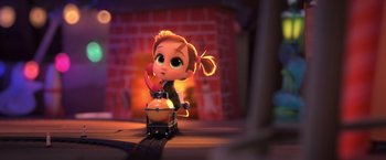 Movie still from “The Boss Baby 2: Family Business” (2021), directed by Tom McGrath – A little girl is riding on a toy train; Medium shot, High angle