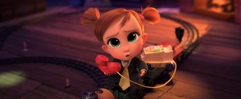 Movie still from “The Boss Baby 2: Family Business” (2021), directed by Tom McGrath – A little girl that is holding a red phone; Medium shot, High angle