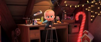 Movie still from “The Boss Baby 2: Family Business” (2021), directed by Tom McGrath – A small baby sitting on top of a stool in a room; Medium shot, High angle