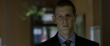 Movie still from “The Bourne Identity” (2002), directed by Doug Liman – A person wearing a suit and tie; Close Up shot, Low angle